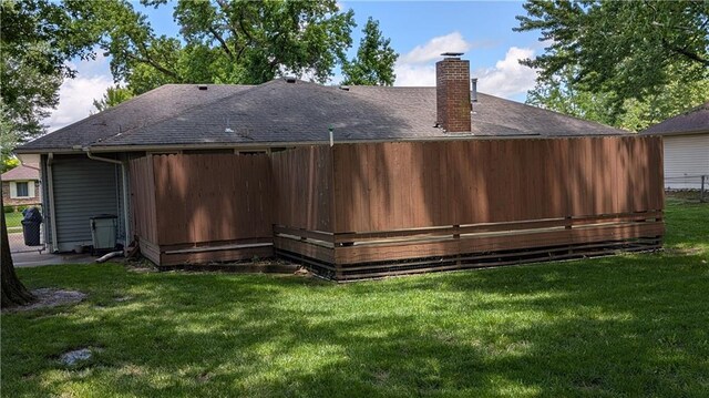2006 Colonial Dr, Pittsburg, KS 66762 - back of house featuring a chimney, a lawn, and roof with shingles