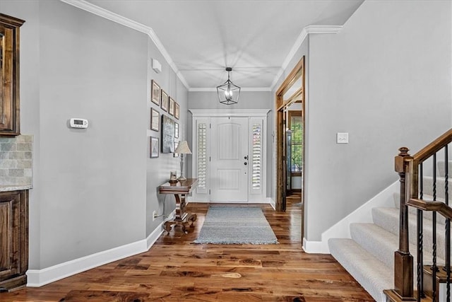 17746 W 165th Pl, Olathe, KS 66062 - entrance foyer with crown molding, wood finished floors, stairway, and a chandelier