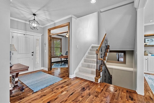 17746 W 165th Pl, Olathe, KS 66062 - foyer entrance with wood finished floors, ornamental molding, stairs, and a chandelier