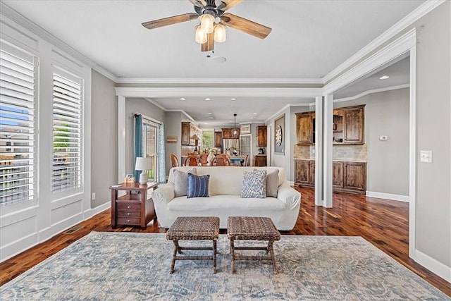 17746 W 165th Pl, Olathe, KS 66062 - living area with healthy amount of natural light, wood finished floors, ceiling fan, crown molding, and recessed lighting