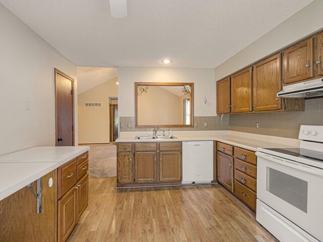 17928 E Whitney Rd, Independence, MO 64057 - kitchen featuring white appliances, under cabinet range hood, brown cabinetry, light wood-style flooring, and recessed lighting