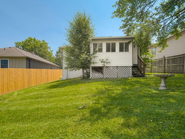 17928 E Whitney Rd, Independence, MO 64057 - back of property with entry steps and a fenced backyard