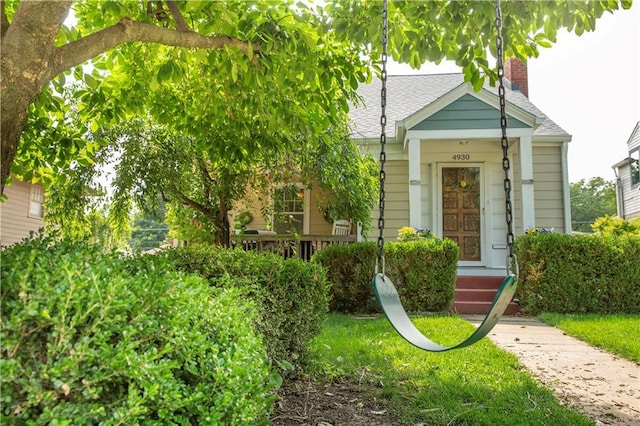 4930 Holly St, Kansas City, MO 64112 - view of front of house with a chimney and a shingled roof