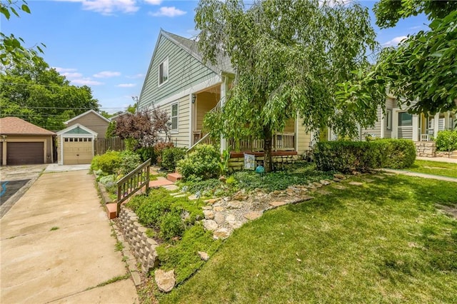 4930 Holly St, Kansas City, MO 64112 - view of property hidden behind natural elements with a garage, an outdoor structure, and a front yard
