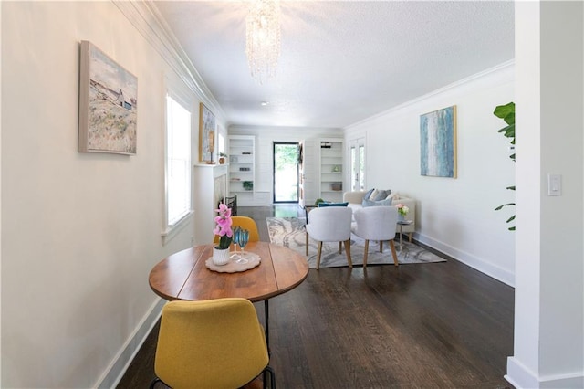 4930 Holly St, Kansas City, MO 64112 - dining area featuring dark wood-style floors, crown molding, a chandelier, built in features, and a textured ceiling