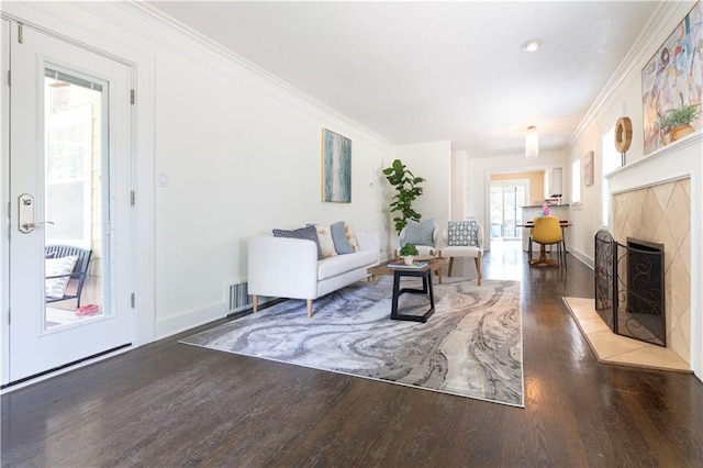 4930 Holly St, Kansas City, MO 64112 - living room with wood finished floors, crown molding, and a fireplace with flush hearth