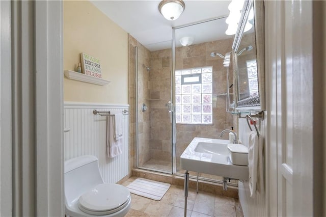 4930 Holly St, Kansas City, MO 64112 - bathroom featuring a stall shower, tile patterned flooring, and wainscoting