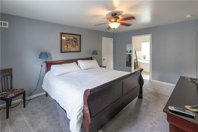 4930 Holly St, Kansas City, MO 64112 - carpeted bedroom with a ceiling fan and ensuite bath