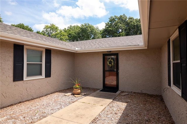 2207 N 154th Ter, Basehor, KS 66007 - doorway to property with stucco siding and a shingled roof