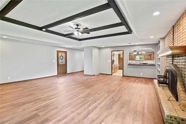 2207 N 154th Ter, Basehor, KS 66007 - unfurnished living room featuring light wood-style flooring, a ceiling fan, recessed lighting, beamed ceiling, and a fireplace