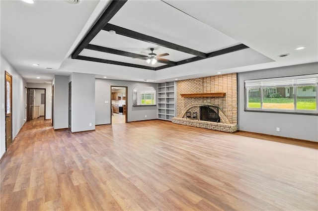 2207 N 154th Ter, Basehor, KS 66007 - unfurnished living room featuring ceiling fan, recessed lighting, light wood finished floors, a fireplace, and built in shelves