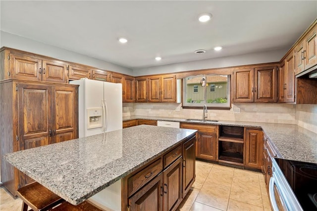 2207 N 154th Ter, Basehor, KS 66007 - kitchen with white appliances, light stone countertops, tasteful backsplash, a kitchen bar, and a kitchen island