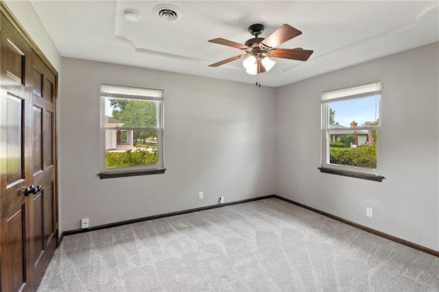2207 N 154th Ter, Basehor, KS 66007 - unfurnished bedroom featuring light colored carpet and a ceiling fan