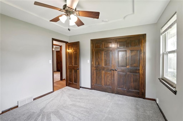 2207 N 154th Ter, Basehor, KS 66007 - bedroom featuring carpet flooring, multiple windows, a closet, and a ceiling fan