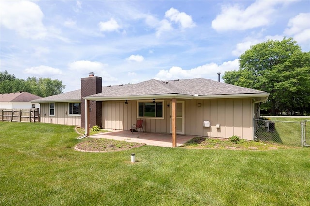 2207 N 154th Ter, Basehor, KS 66007 - rear view of house featuring a patio, a chimney, ceiling fan, board and batten siding, and roof with shingles