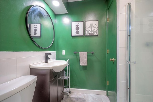 5603 Cody St, Shawnee, KS 66203 - bathroom with vanity, a shower with shower door, and tile walls
