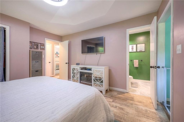 5603 Cody St, Shawnee, KS 66203 - bedroom with light wood finished floors and ensuite bathroom