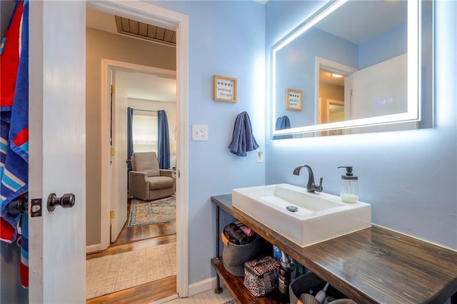 5603 Cody St, Shawnee, KS 66203 - bathroom featuring wood finished floors and a sink