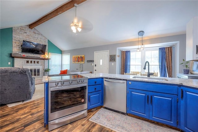 5603 Cody St, Shawnee, KS 66203 - kitchen featuring appliances with stainless steel finishes, blue cabinetry, wood finished floors, and open floor plan