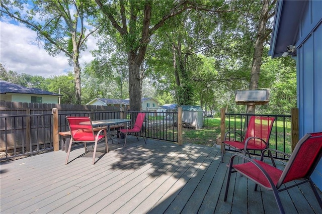 5603 Cody St, Shawnee, KS 66203 - deck with a fenced backyard, outdoor dining area, and view of wooded area