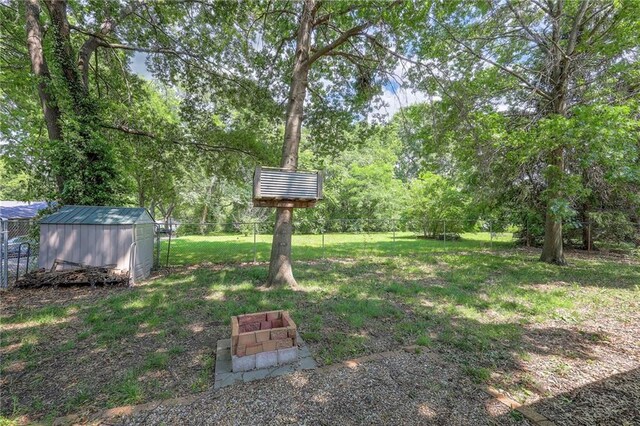 5603 Cody St, Shawnee, KS 66203 - fenced backyard featuring a storage shed