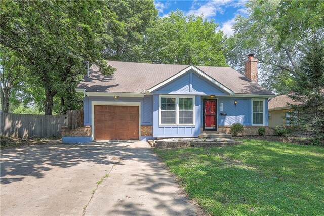 5603 Cody St, Shawnee, KS 66203 - ranch-style home with an attached garage, driveway, and a chimney