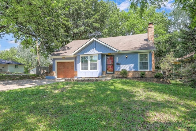 5603 Cody St, Shawnee, KS 66203 - ranch-style home featuring an attached garage, a chimney, concrete driveway, and a front yard