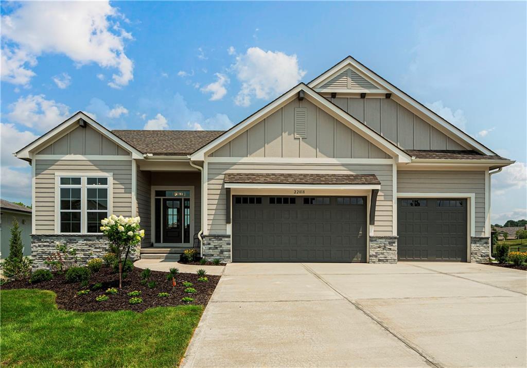 11434 S Montclaire Dr, Olathe, KS 66061 - craftsman inspired home featuring stone siding, a garage, board and batten siding, and driveway