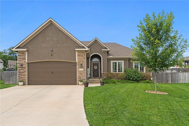 1402 NW Red Oak Ct, Grain Valley, MO 64029 - view of front of house with an attached garage, concrete driveway, stucco siding, and stone siding