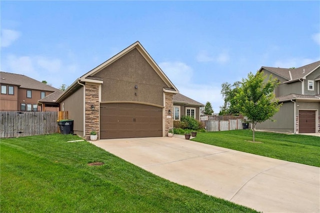 1402 NW Red Oak Ct, Grain Valley, MO 64029 - view of front facade featuring concrete driveway, an attached garage, and stone siding