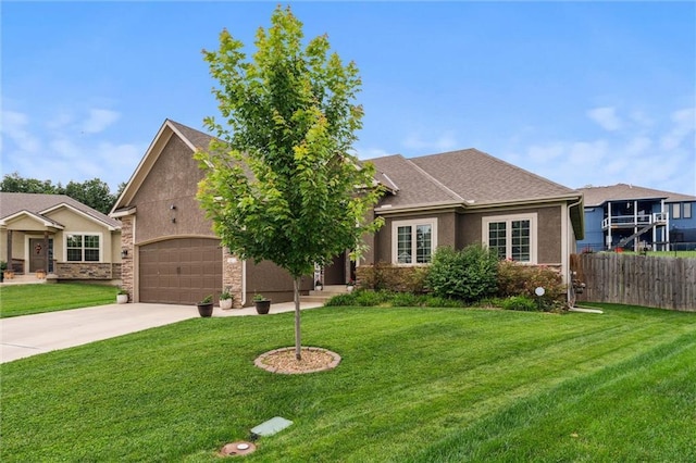1402 NW Red Oak Ct, Grain Valley, MO 64029 - view of front of house featuring driveway, a garage, and stucco siding