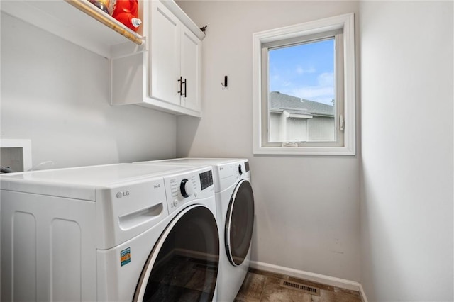 1402 NW Red Oak Ct, Grain Valley, MO 64029 - laundry area with cabinet space, washing machine and clothes dryer, and stone finish floors