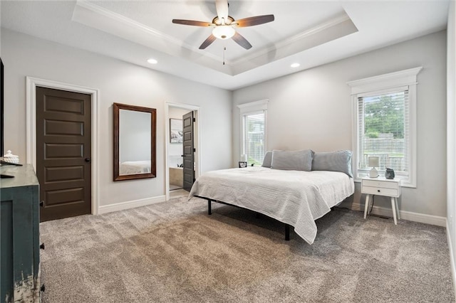 1402 NW Red Oak Ct, Grain Valley, MO 64029 - carpeted bedroom featuring a tray ceiling, ornamental molding, multiple windows, recessed lighting, and a ceiling fan