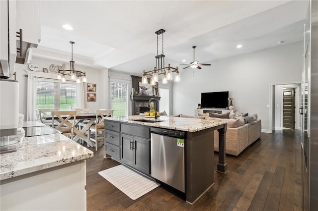 1402 NW Red Oak Ct, Grain Valley, MO 64029 - kitchen featuring dishwasher, ceiling fan, a fireplace, dark wood-type flooring, and recessed lighting