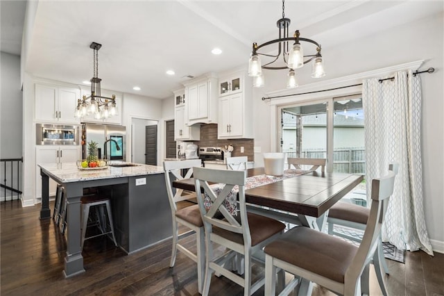 1402 NW Red Oak Ct, Grain Valley, MO 64029 - dining room with a chandelier, dark wood-type flooring, and recessed lighting