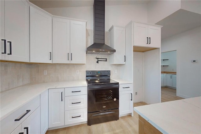350 NW 1201st Rd, Holden, MO 64040 - kitchen featuring black range with electric cooktop, wall chimney exhaust hood, light wood-type flooring, and backsplash
