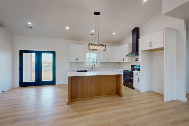 350 NW 1201st Rd, Holden, MO 64040 - kitchen featuring black range with electric cooktop, a center island, light wood finished floors, light countertops, and vaulted ceiling