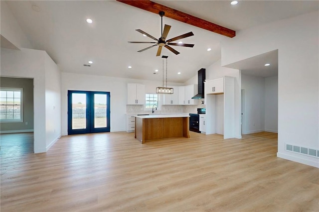 350 NW 1201st Rd, Holden, MO 64040 - kitchen with black / electric stove, open floor plan, light countertops, wall chimney range hood, and a center island