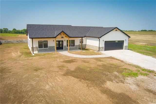 350 NW 1201st Rd, Holden, MO 64040 - modern farmhouse with stone siding, french doors, driveway, a garage, and a shingled roof