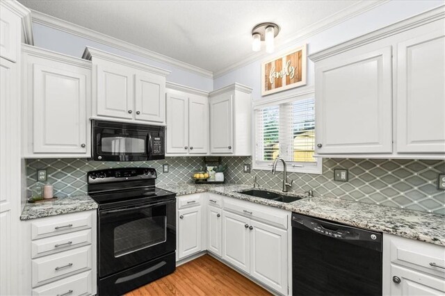 600 SW Gentry Ln, Lees Summit, MO 64081 - kitchen featuring black appliances, ornamental molding, white cabinets, and backsplash