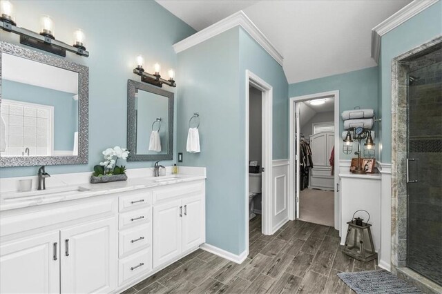 600 SW Gentry Ln, Lees Summit, MO 64081 - full bath with a stall shower, double vanity, wood tiled floors, a wainscoted wall, and a walk in closet