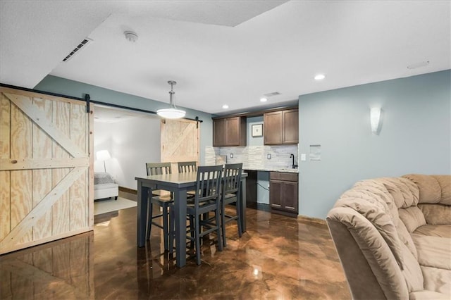 600 SW Gentry Ln, Lees Summit, MO 64081 - dining space with a barn door, concrete flooring, and recessed lighting