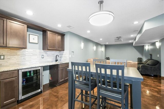 600 SW Gentry Ln, Lees Summit, MO 64081 - indoor bar with wine cooler, recessed lighting, backsplash, and concrete flooring