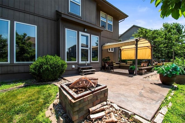 600 SW Gentry Ln, Lees Summit, MO 64081 - back of property with a patio area, entry steps, and an outdoor living space with a fire pit