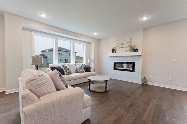 1913 SW Hightown Dr, Lees Summit, MO 64082 - living area featuring dark wood-style flooring, a tiled fireplace, baseboards, and recessed lighting