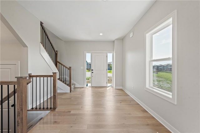 1913 SW Hightown Dr, Lees Summit, MO 64082 - foyer entrance featuring healthy amount of natural light, light wood-style floors, baseboards, stairway, and recessed lighting