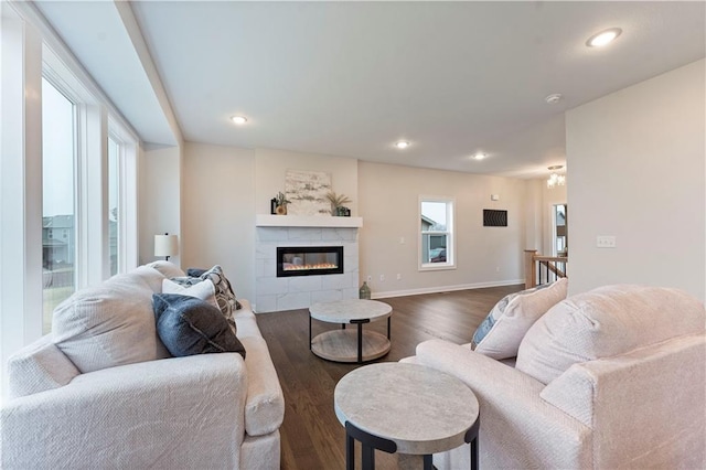 1913 SW Hightown Dr, Lees Summit, MO 64082 - living room with dark wood-style floors, a tiled fireplace, recessed lighting, and baseboards