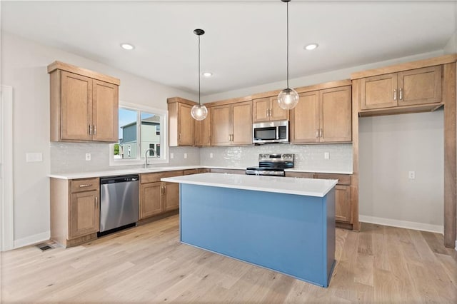 1913 SW Hightown Dr, Lees Summit, MO 64082 - kitchen with stainless steel appliances, light wood-type flooring, light countertops, tasteful backsplash, and recessed lighting