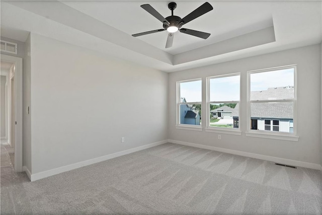 1913 SW Hightown Dr, Lees Summit, MO 64082 - empty room with baseboards, light carpet, a raised ceiling, and a ceiling fan