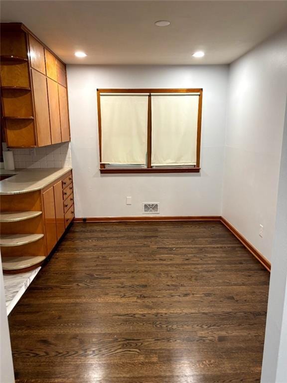 2838 N 64th Ter, Kansas City, KS 66104 - unfurnished dining area featuring dark wood finished floors, baseboards, and recessed lighting